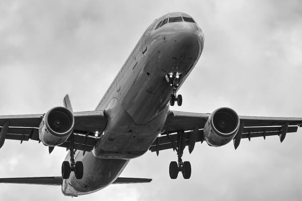 Aircraft viewed from below against clouds